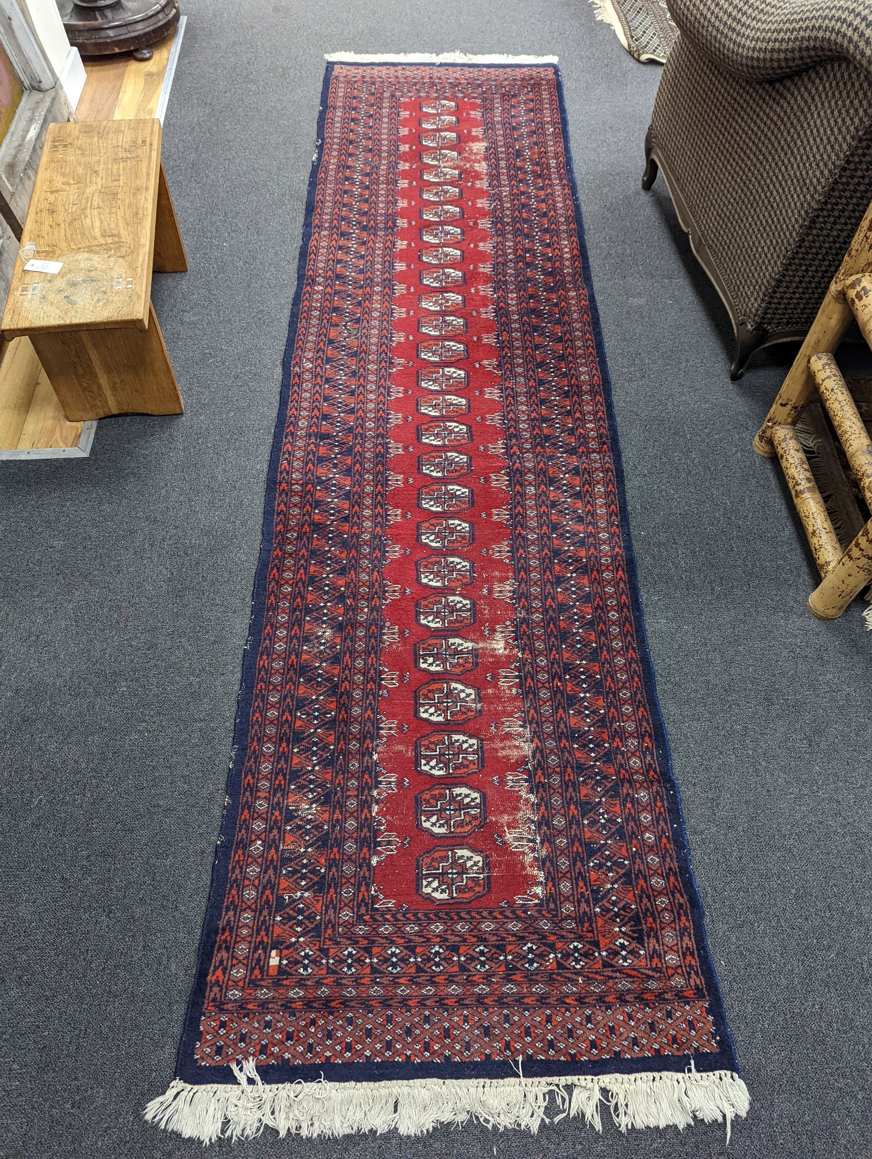 A Caucasian red ground rug and a Bokhara runner, rug 180 x 120 cms